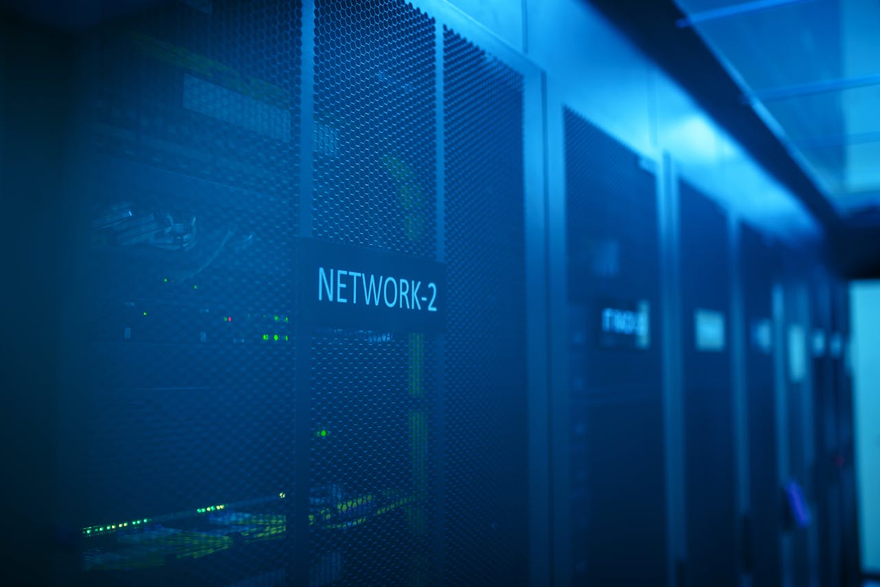 hero-img-02 A modern server room featuring network equipment with blue illumination. Ideal for technology themes.